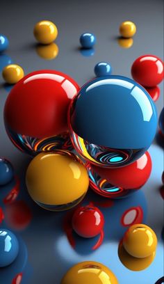 an array of different colored balls on a gray surface with blue, yellow and red ones