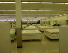 there are many mattresses in this large room