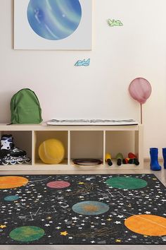 a child's play room with toys and space themed rugs on the floor