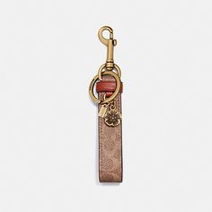 a keychain with a red and gold charm hanging from it's side