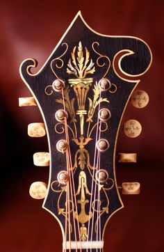 an intricately designed guitar with gold and black details