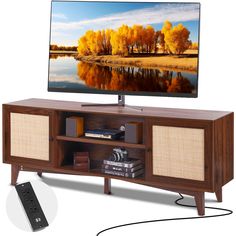 a flat screen tv sitting on top of a wooden entertainment center next to a remote control