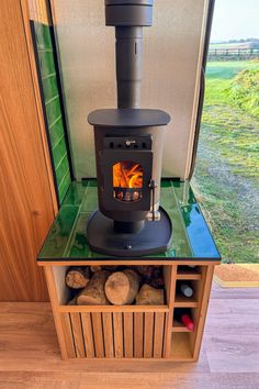 Log burner in campervan with log storage beneath Log Burner In Static Caravan, Campervan Log Burner, Log Burner Storage, Camper Wood Stove, Campervan Makeover, Crafter Campervan, Van Conversion Ideas, Camper Stove, Lounge Seating Area