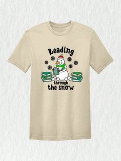 Imagine yourself at the library during the holiday season, surrounded by shelves lined with books. As you make your way through the stacks, you stumble upon a t-shirt that perfectly captures the magic of Christmas and the love for reading. Our Christmas Reading Through The Snow Shirt is the perfect gift for teachers and bookworms alike. Get ready to show off your love for books with this delightful and festive tee.Christmas Reading Through The Snow Shirt, Christmas Library T-Shirt, Bookworm Christmas Tee, Gift For Teachers Sand Casual  Short Sleeve  Animal,Cartoon,Christmas,Colorblock,Figure,Geometric,Graphic,Letter,Striped,Plants,Slogan,Textured Pattern    Women Clothing, size features are:Bust: ,Length: ,Sleeve Length: Christmas Library, Stand Collar Top, Christmas Reading, Cartoon Christmas, Cute Letters, The Magic Of Christmas, Magic Of Christmas, Animal Cartoon, Geometric Graphic