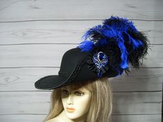 "Black Cavalier woolen hat with black braided trim, black and royal blue ostrich plumes, black cocarde with a sparkly jewel center. This hat is 22.5\" for the inside circumference but does have a built-in hat sizer. I'm sorry, I cannot make the inside circumference bigger. Check out my other cavalier and pirate hats in my etsy shop. I ship Priority mail. I ship many times a week. If you need your item quicker let me know your zip code and I can figure shipping rates for you. Please let me know if you have any questions I accept Paypal, credit cards and etsy gift cards   All sales are FINAL, no returns or exchanges please keep this in mind before purchasing. International buyers: Please know that you will be held responsible for any CUSTOMS FEES. Please check with you local post office, bef Fitted Black Hat For Carnival, Black Hat For Carnival, Western Black Hat With Feathers, Black Western Hat With Feathers, Cavalier Hat, Musketeer Hat, Random Oc, Ren Fest, Pirate Hat