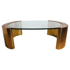 an oval glass and brass coffee table