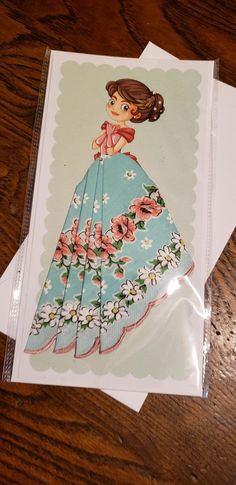 "Handkerchief card; This is a new card and handkerchief; it measures 5\" x 10\" and is printed on heavy cardstock; it comes with an envelope for mailing. It shows a fresh faced young lady, and her skirt is actually a handkerchief- aqua with lovely multi colored flowers. Very beautiful! Old fashioned. I will have many different designs of these handkerchief cards. Mix and match!" Handkerchief Cards, Hankerchief Skirt, Hanky Dress, Teacher Craft, Multi Colored Flowers, Reading Pa, Beautiful Greeting Cards, Colored Flowers, Clever Ideas