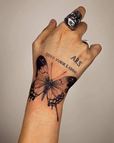 a hand with a butterfly tattoo on it's wrist and the words abs above it