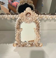 there is a mirror with shells on it