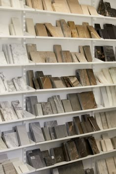 many different types of tile on shelves in a store