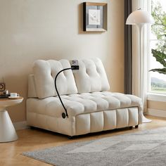 a white couch sitting on top of a hard wood floor