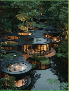 the circular building is surrounded by trees and water, with many windows on each side