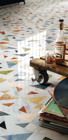 a table with some bottles on top of it next to a couch and coffee table