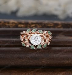 an engagement ring with green and white stones