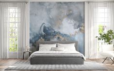 a bedroom with a large painting on the wall and a bed in front of it