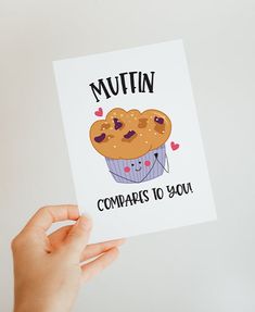 a hand holding up a card with a muffin on it that says, comparas to you