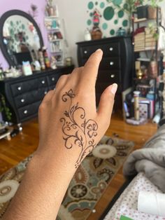 a woman's hand with a tattoo on it