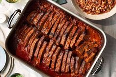 the meat is cooked and ready to be served in the dish on the table with other dishes