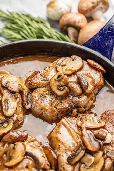 mushrooms are being cooked in a skillet on the stove with garlic and green beans