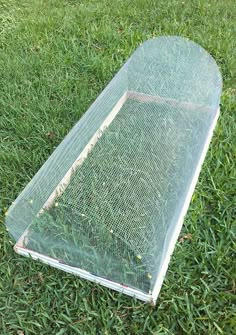 an empty plastic box sitting in the grass