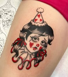 a woman's leg with a tattoo on it that has an image of a clown wearing a party hat