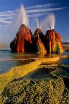 three geysers are spewing out from the water