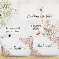 three white flowered bags with the names of bride and groom on them, sitting next to each other