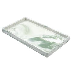 a white and green marble tray on a white background with an abstract design in the center