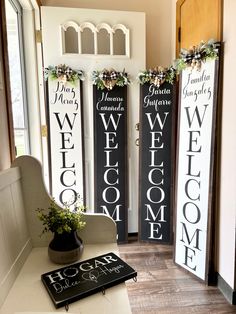 three welcome signs are on display in front of a door