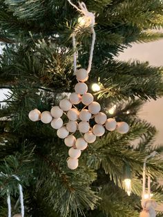 an ornament hanging from the top of a christmas tree with lights on it