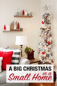 a small christmas tree in the corner of a living room with red and white decorations