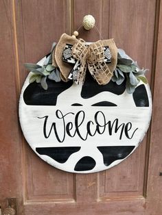 a welcome sign hanging on the front door