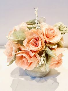 a vase filled with pink flowers on top of a table