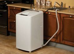 a white refrigerator sitting in the middle of a kitchen next to a stove top oven