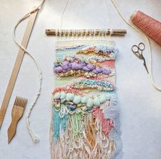 a weaving project with yarn, scissors and thread