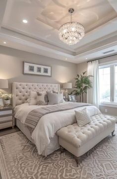 a bedroom with a large bed and chandelier