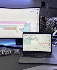 two computer monitors sitting on top of a desk next to a keyboard and monitor screen