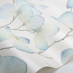 a wallpaper with blue flowers and leaves on it's back drop in the background