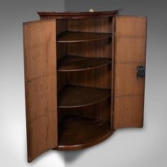 a wooden cabinet with three shelves on one side and two doors on the other end