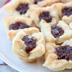 small pastries on a plate with jam in the middle