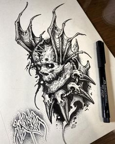 a drawing of a demon head on paper