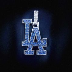 the los angeles dodgers logo is shown in blue and white crystal beads on a black background