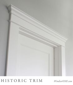 a white door frame with the words historic trim on it in front of a gray wall