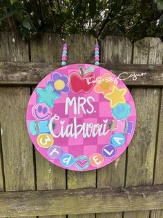 a wooden sign that says mrs calaveri on the side of a wood fence