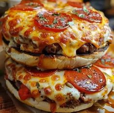 three pizzas stacked on top of each other with cheese and toppings all over them