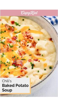 a close up of a bowl of food with cheese and bacon on top, sitting on a table