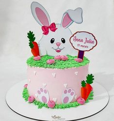 a pink cake decorated with an easter bunny