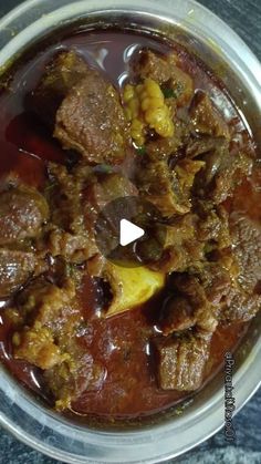 a bowl filled with meat and vegetables on top of a table