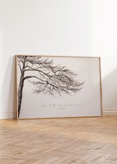 an art piece is displayed on the floor in front of a wall with a tree