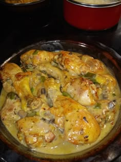 a pan filled with chicken and vegetables covered in gravy